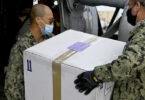 Navy Chief Petty Officers assigned to the Defense Logistics Agency Distribution Sigonella, load a box of COVID-19 vaccines onto a MH-60S Sea Hawk helicopter, assigned to the Helicopter Sea Combat Squadron 7, for transportation to the Nimitz-class aircraft carrier USS Dwight D. Eisenhower from Naval Air Station Sigonella, in Sigonella, Italy, March 10, 2021.